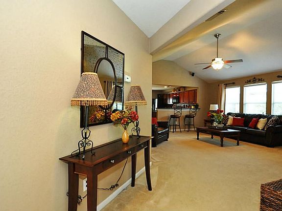 The open living room has custom paint and wonderful architectural ceiling details.