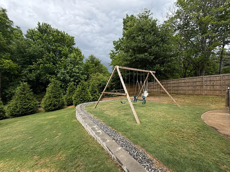 Private back yard with large swing set