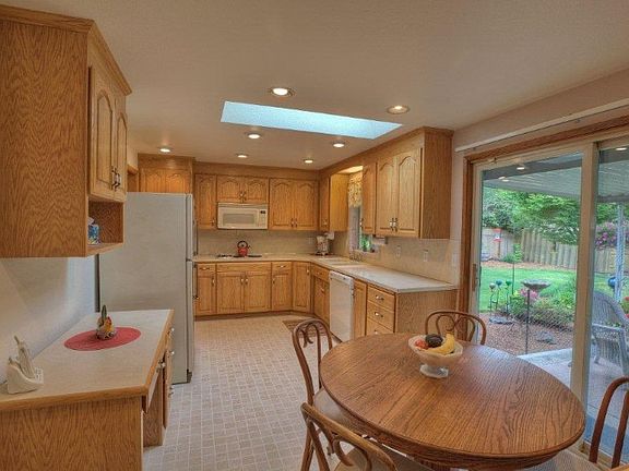 Newer cabinets & appliances. New windows and slider out to covered patio and backyard.