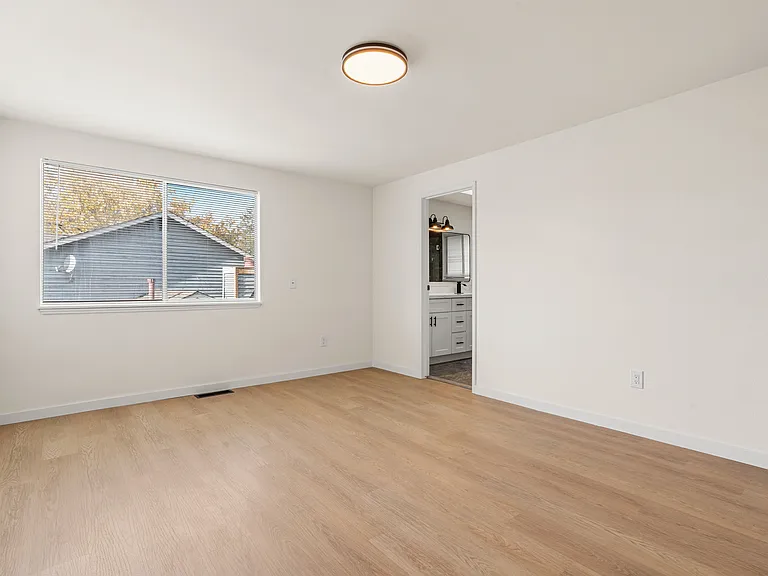 Great-sized master bedroom with a beautifully remodeled ensuite, showcasing a double-sink vanity and a sleek, modern shower.