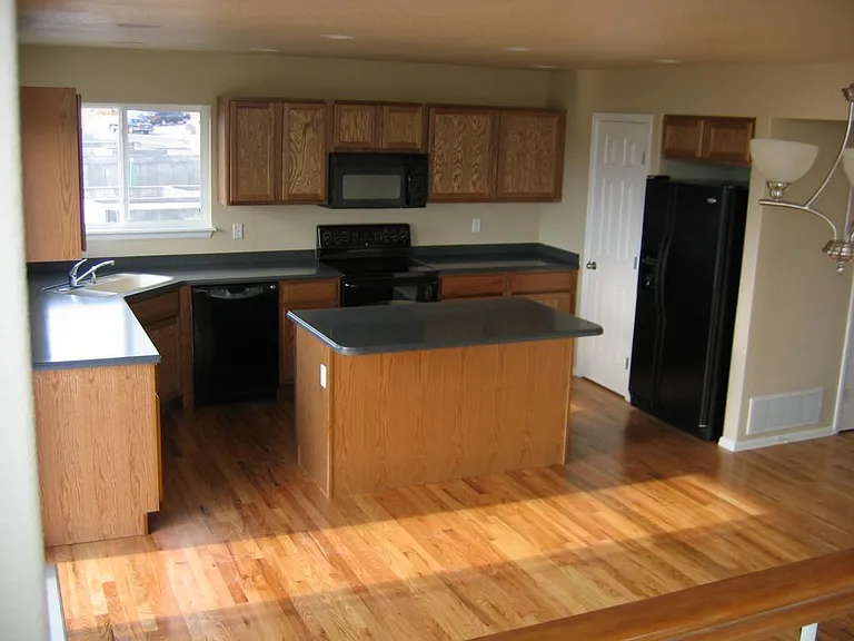 Overall view of the kitchen. The hallway to the garage and laundry is at the far right.