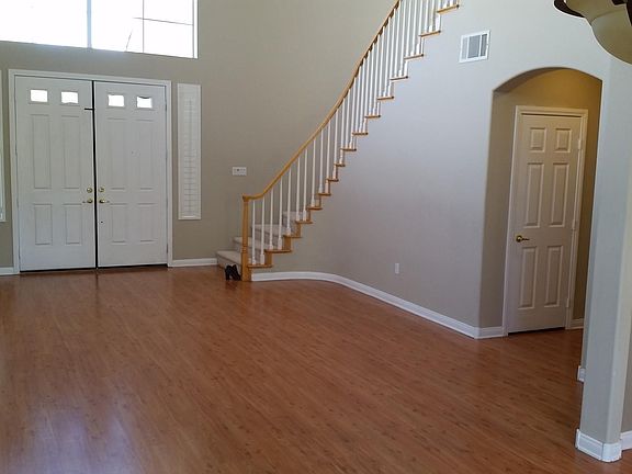 Step Inside to the large living room. Stairs lead to the four bedrooms, hallway leads to coat closet, laundry room, downstairs bath, and garage. All wood floors downstairs. All carpet upstairs.