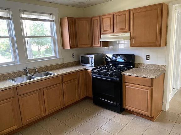 Kitchen with oven, microwave and double sink.