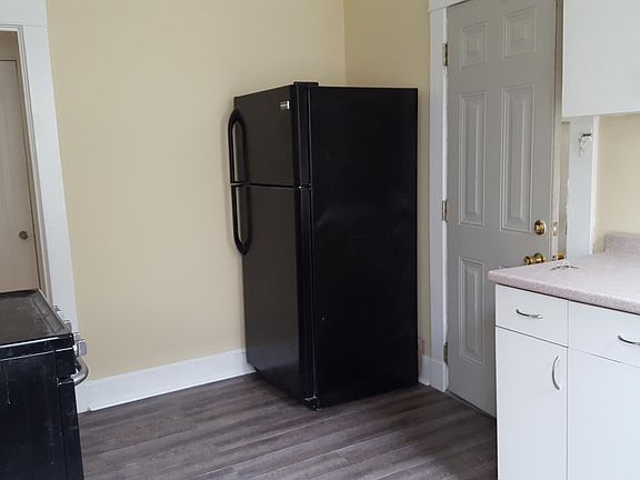 kitchen has new electric stove and refrigerator