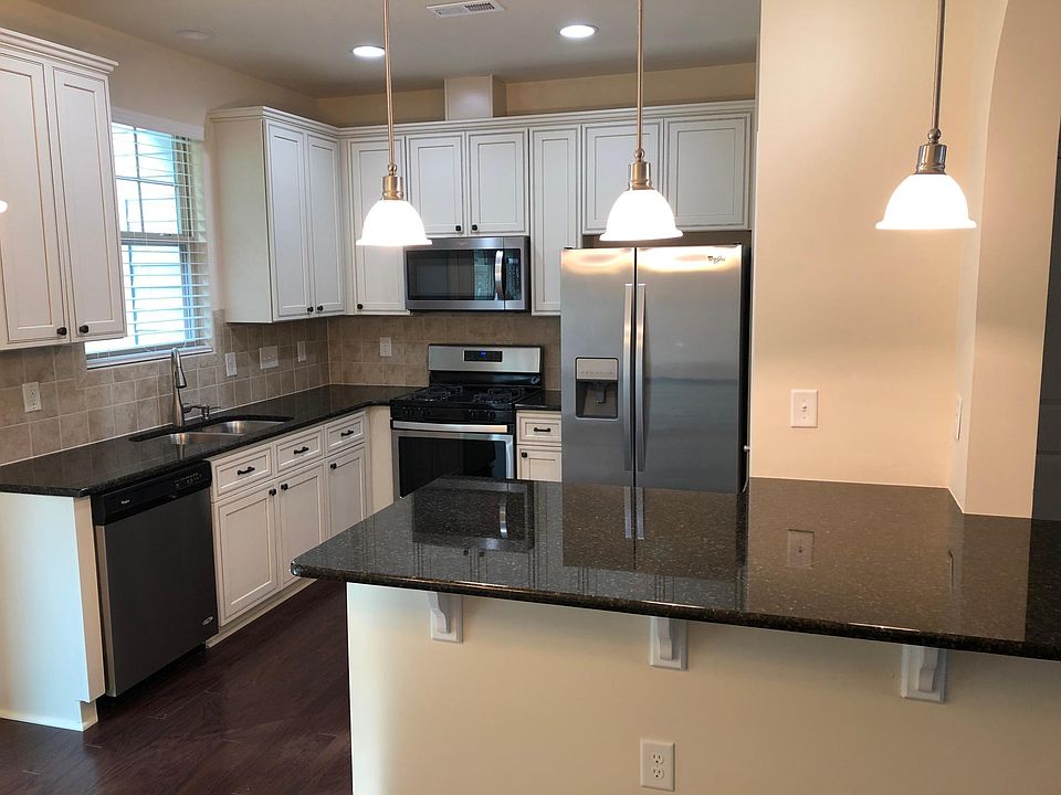 Brand new cabinets, backsplash, wood flooring, gas range and microwave!