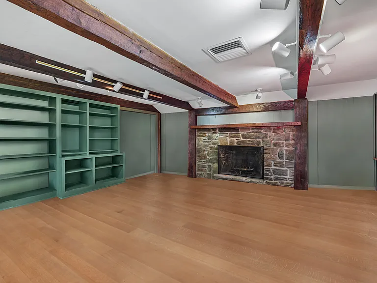 Family room with oversized fireplace, built-ins and library