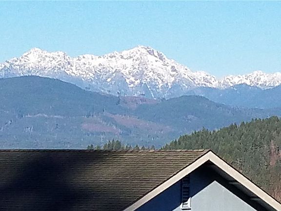 Olympic Mtn view over neighbor's roof across the street to the left, (SW). (zoomed in).