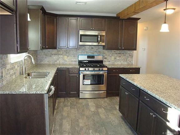 New kitchen with maple cabinets, granite, SS appliances, tile flooring, lighting, etc...