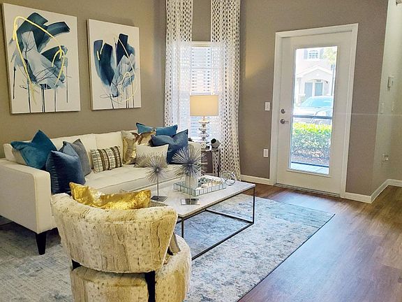 Spacious living rooms featuring wood-style flooring and plenty of natural sunlight.