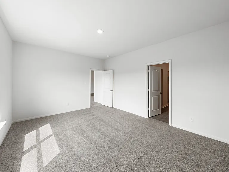 The master suite has a large bedroom, en-suite bathroom and walk-in closet.