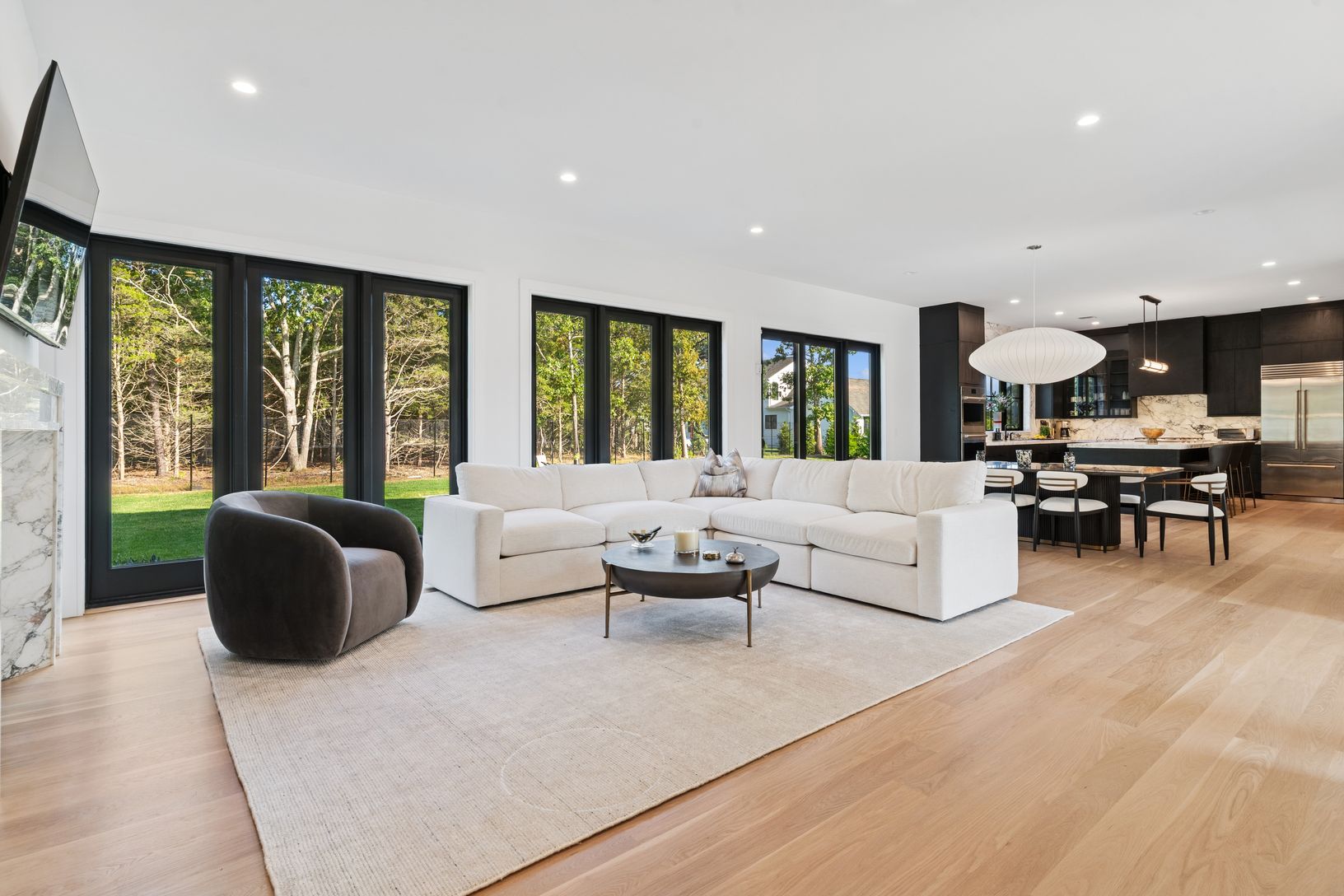  Open Plan living room with access to the verdant outdoors, and sliding doors to the pool