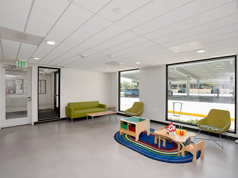 Kid-friendly play area with natural light and colorful, engaging furniture designed for fun.