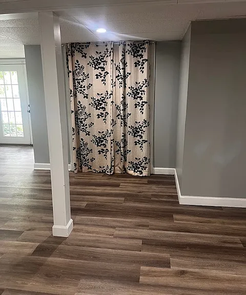 Walk-in closet in basement (curtained doorway)