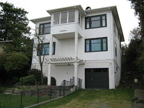 Back of the home showing all three levels and sun room addition off the top floor.