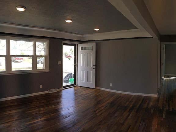 Living room and hallway towards bathroom and second and third bedrooms