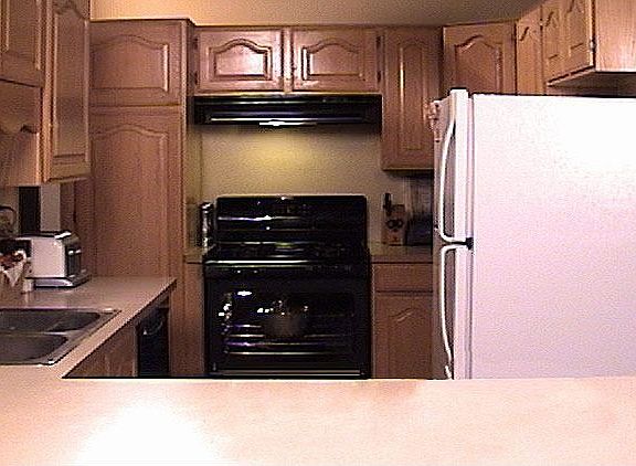 Lots of cabinet space in the kitchen and a high, open ceiling above.