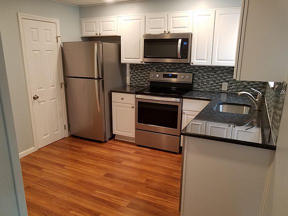 Pantry next to refrigerator. Granite counter tops and finger print free stainless steel appliances.