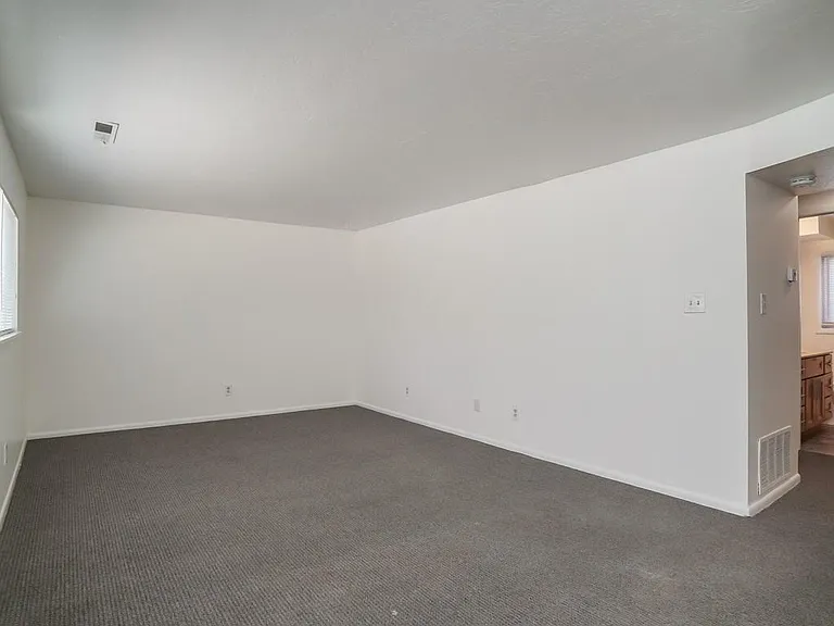 Living Room With Attractive Large Window & Hall Access to Bathroom, Both Bedrooms and Apartment Entry Door