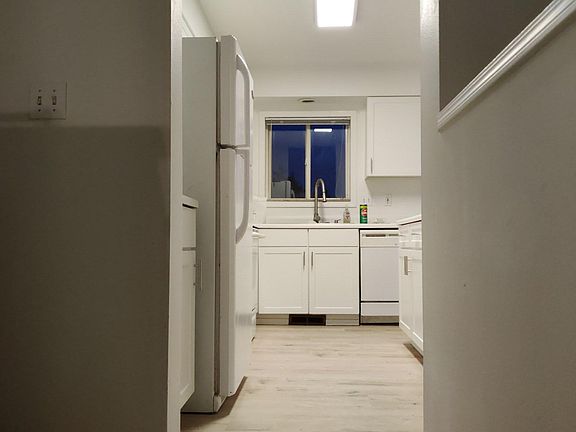 Kitchen opens to living area below and stairs