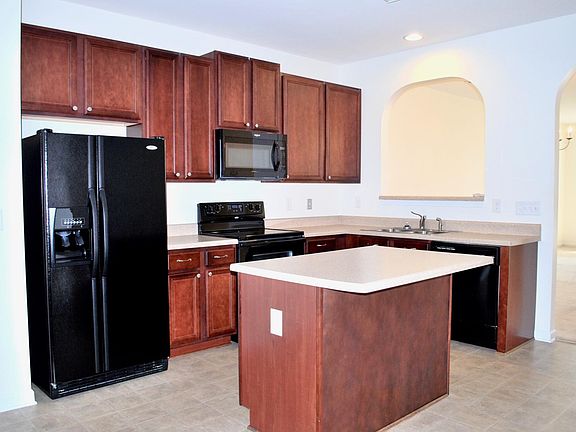 kitchen view with a pass window to the dining area