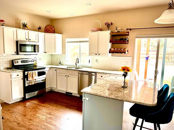 Open kitchen space with new Granite Counter top installed in 2021 .