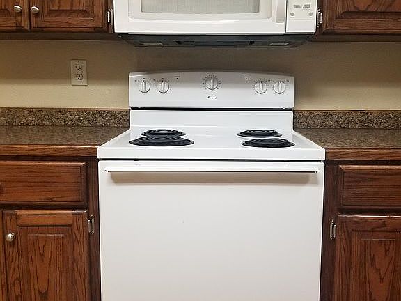 Electric stove with combination microwave and vent-a-hood
