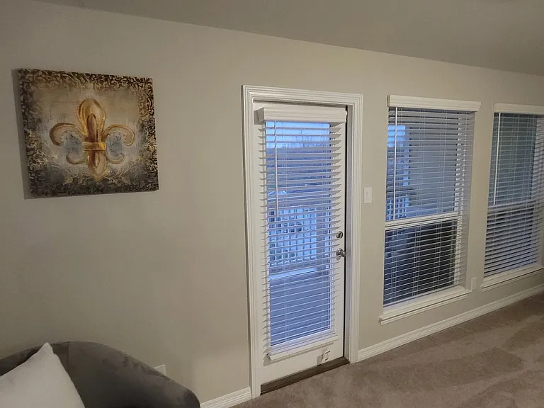 Door to private balcony in primary bedroom