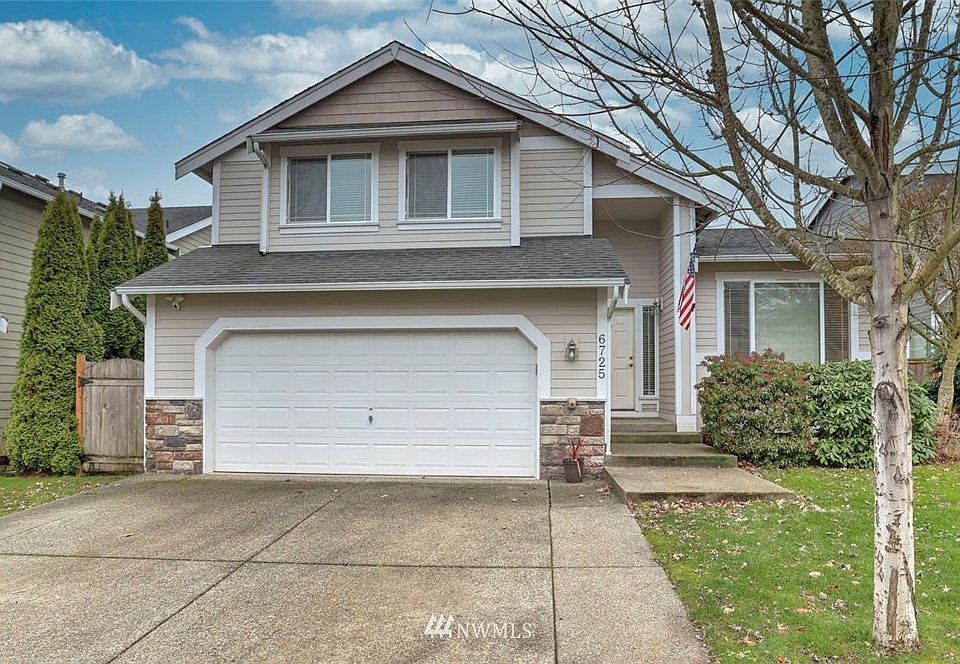 Beautifully landscaped yard with extra wide driveway.