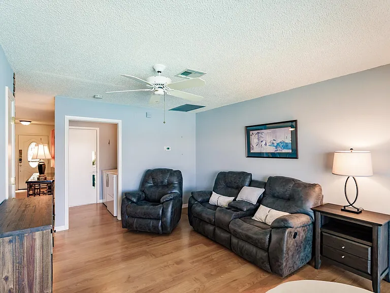 TV room toward indoor laundry room and entrance far left into living room