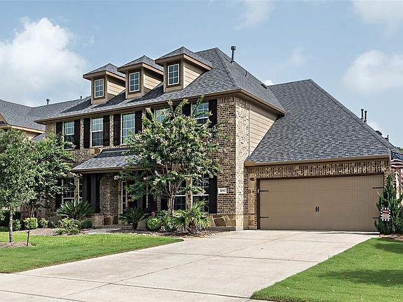 A view of the front of home with double wide driveway leading to 3 car Garage!