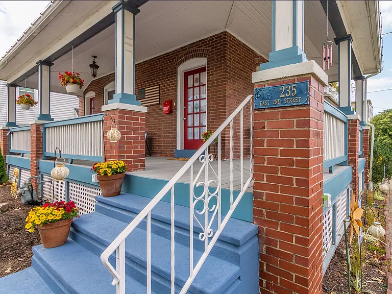 Stairs leading up to wrap around porch