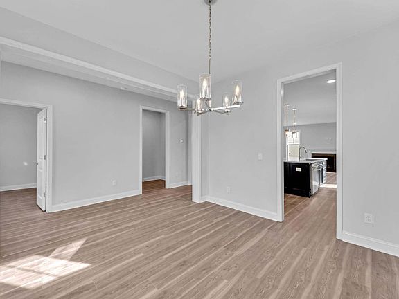 Formal Dining room with beautiful pendant lighting nestled off of Foyer.