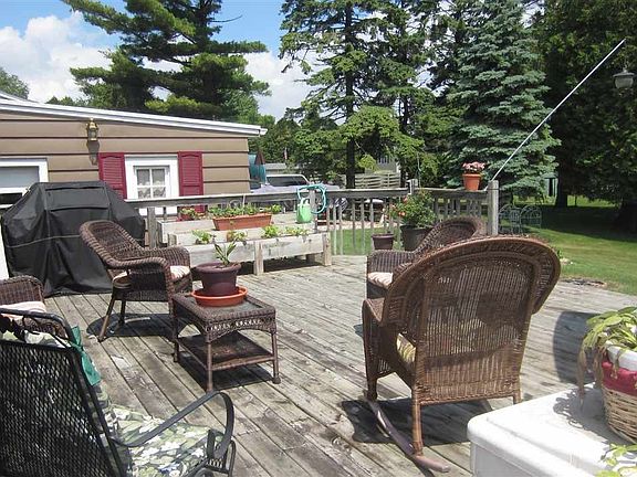 Relax on the large wood deck enjoying beautiful views of your yard & West Twin River beyond
