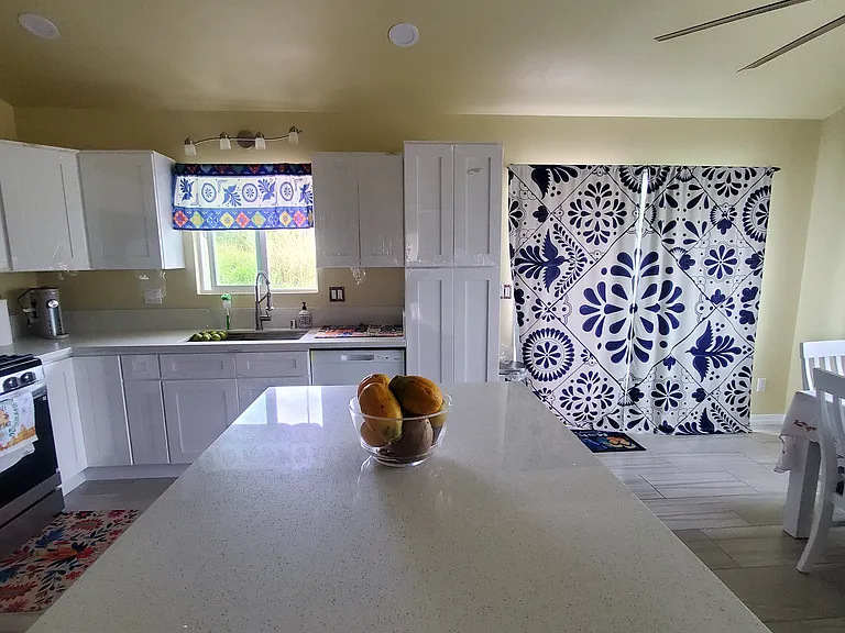 New, beautifully decorated kitchen with Mexican Talavera art. 
4 sitting stools for central Kitchen Island. 
Ample center island for breakfast, baking and organizing your groceries. 
Tall pantry. 
Six seat long dinning table.