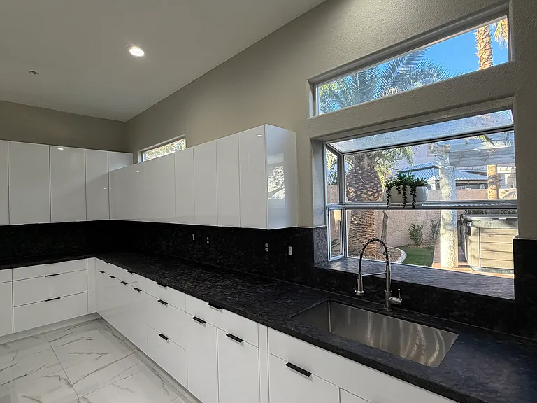 Kitchen sink with backyard view.