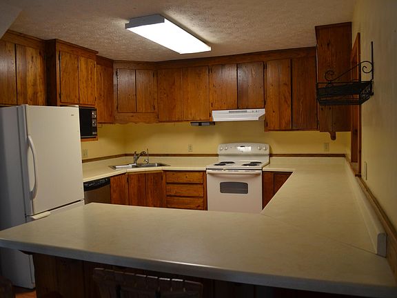 Kitchen with custom wormy chestnut cabinets. Microwave is not part of the rental.