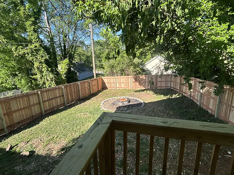 fenced in backyard with fire pit