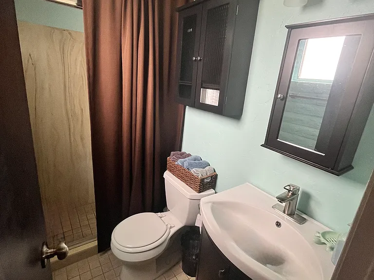 Master bath is 1 3/4 with a shower and extra cabinets for storage.