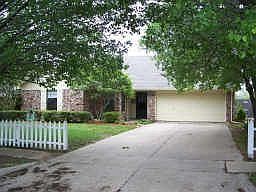 white picket fence front lrg shade trees