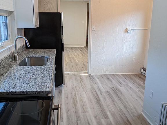Kitchen and dining area, view into living room/bedroom