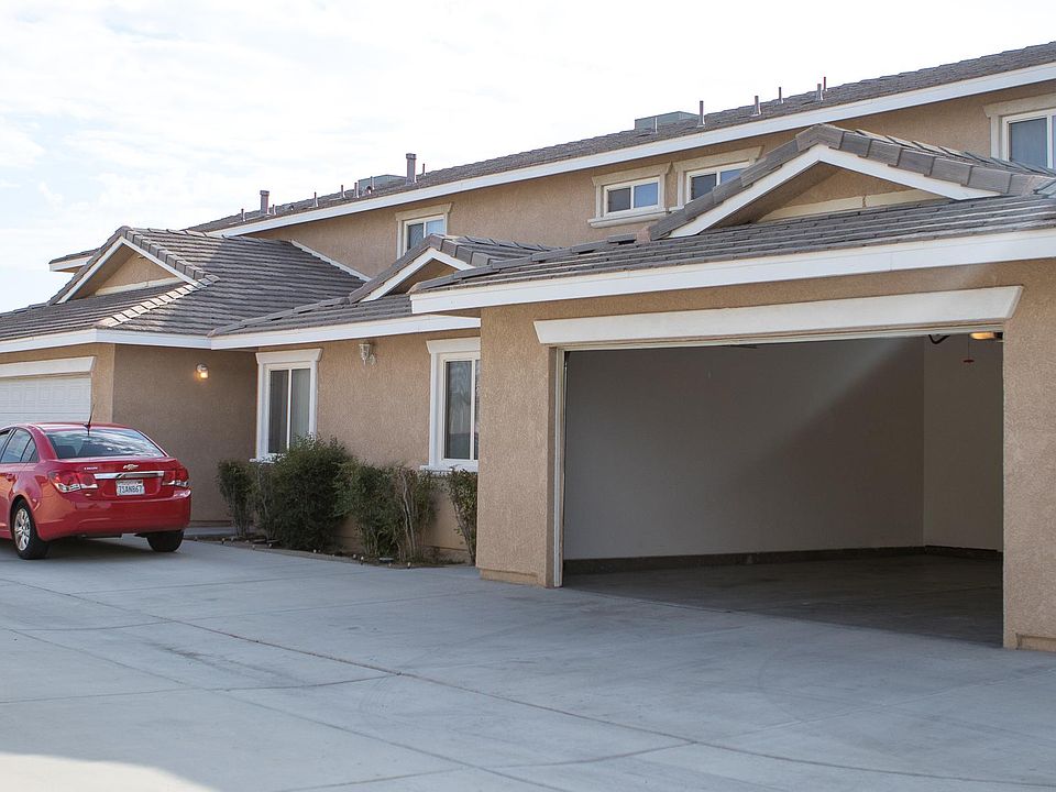 Exterior view of triplex w/ 2 car garage and private entrances