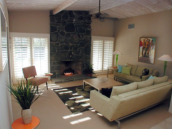 living room with classic floor to ceiling fireplace