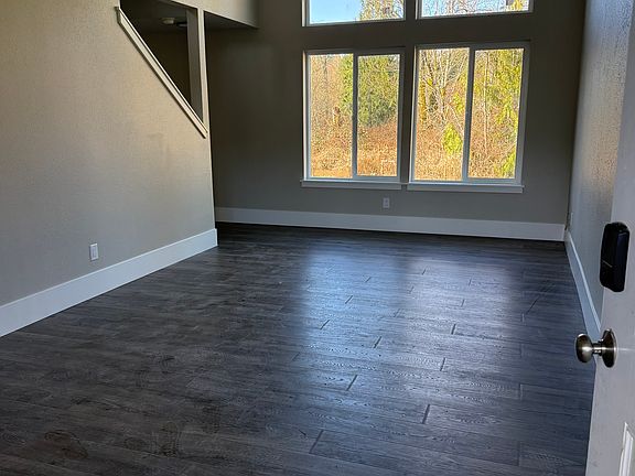 Living Room with new luxury vinyl plank flooring, vaulted ceiling with skylight and new double-pane high efficiency windows