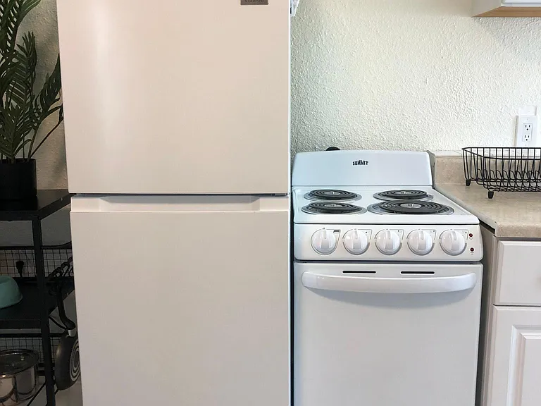 Studio: Mid size refrigerator with freezer, electric stovetop, microwave