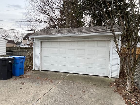 Two car garage with electric overhead door.