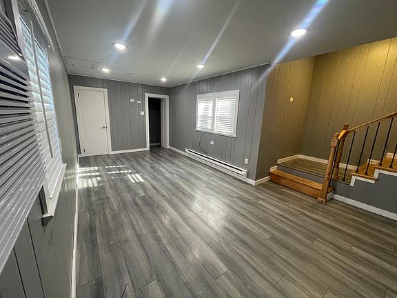 Living room with original built-ins and access to half bath