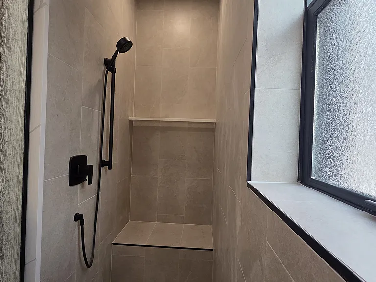 Walk-in shower with bench, soap ledge and rainshower plus wall mounted hand-held