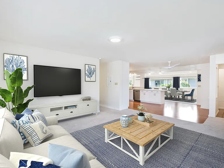 Looking from living room across eat in kitchen and into separate dining area.