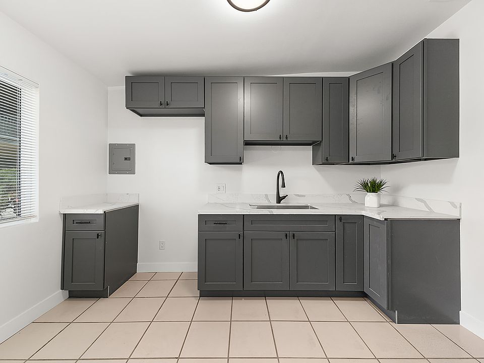 spacious kitchen with eating area light and bright, tile floors