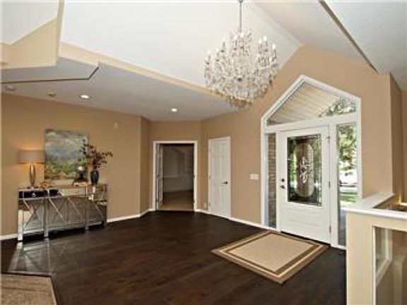 Very large and inviting front entry way with large glass chandelier.